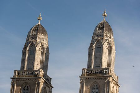 Two medieval church towers against a clear blue sky in the old city center of Zurich, Switzerland. Swiss Grossmunster cathedral towers in the morning light.の写真素材