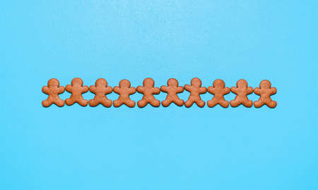 Above view with homemade gingerbread cookies on a blue background. Flat lay with gingerbread man...
