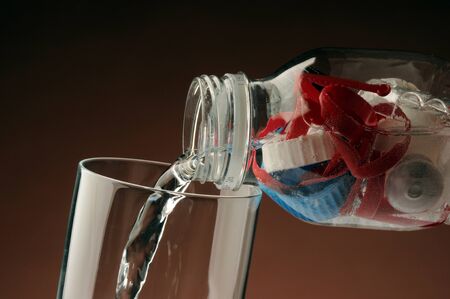 Mineral water bottle filled with plastic.の写真素材