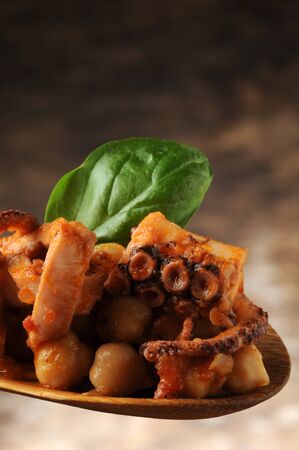 Octopus salad with chickpeas on the spoonの写真素材