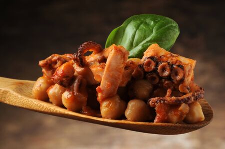Octopus salad with chickpeas on the spoonの写真素材