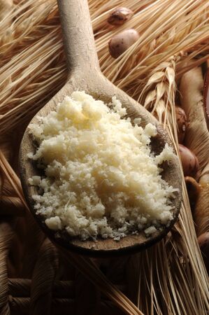 Close up of a spoonful of parmesan cheese on barleyの写真素材
