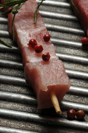 Raw arrosticini in the cooking panの写真素材
