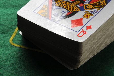 Deck of poker cards on green table