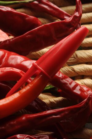 Cap of a red pen on hot pepperの写真素材