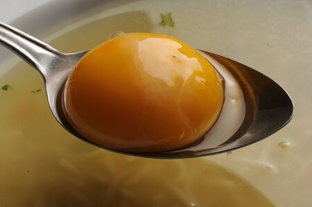 Yolk of chicken eggs on soup