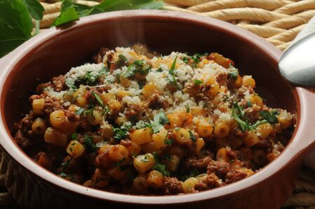 Plate of short pasta with meat sauce and Parmigiano cheeseの写真素材