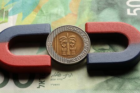 Israeli coin with magnets on banknote,の写真素材