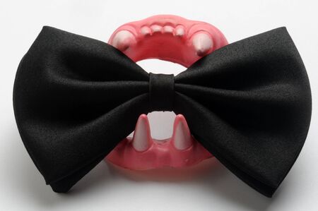 Black bow tie with Dracula's denture.の写真素材