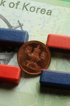 South Korean coin with magnet on banknoteの写真素材