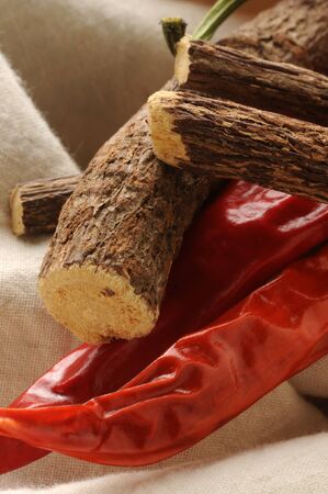 Dried sticks of liquorice root and chili pepperの写真素材