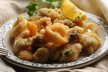 Fried fish dish with lemon slice.