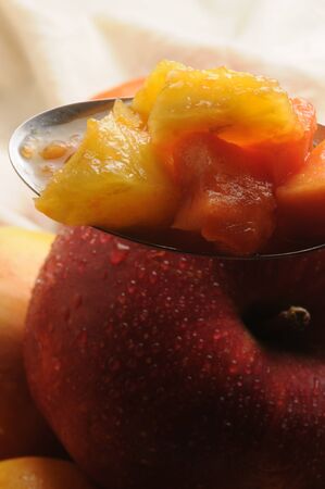 Close up on fruit salad in spoonの写真素材