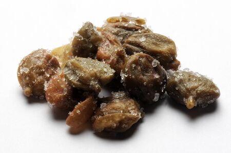 Capers under salt on a white backgroundの写真素材