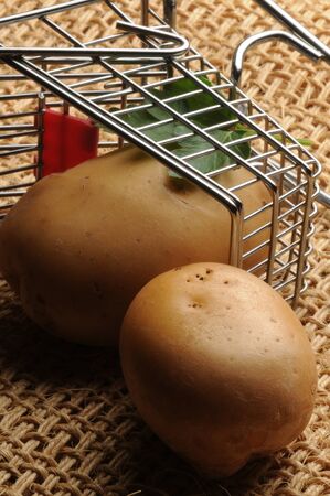 Raw potatoes in the shopping cartの写真素材