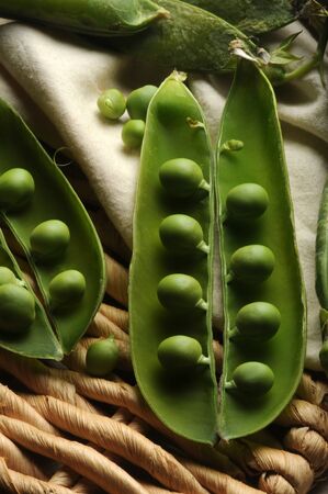 Fresh peas with pods on the basketの写真素材