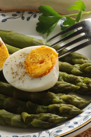 Boiled eggs with green asparagusの写真素材