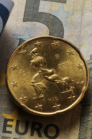 Italian euro coin on banknotes