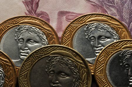 Closeup on brazilian banknote and coinsの写真素材