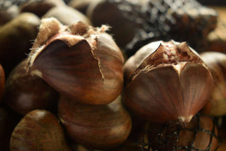 Closeup of roasted chestnuts with the typical cut for cookingの写真素材