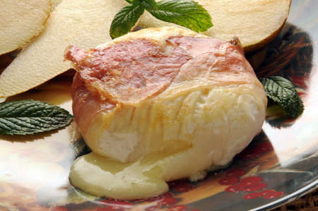 Traditional italian cheese tomino with baconの写真素材