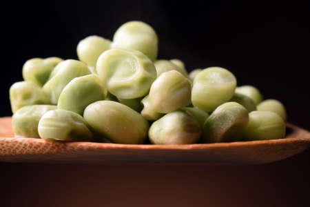 Frozen broad beans on wooden spoonの写真素材