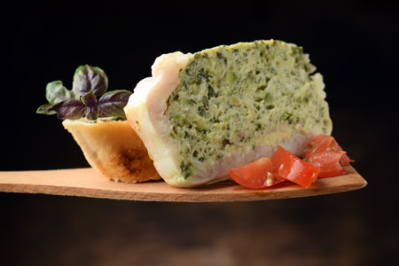 Fish flan with tomatoes and slice of breadの写真素材