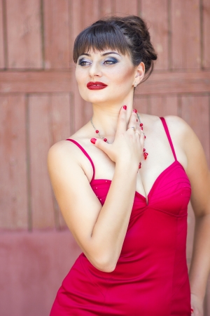 Portrait of a brunette woman in sexy red dressの写真素材