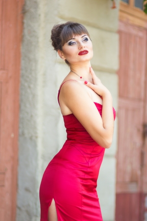 Portrait of a brunette woman in sexy red dressの写真素材
