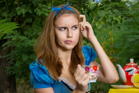 Portrait of beautiful brown-haired girl in a suit of Alice in Wonderlandのeditorial素材