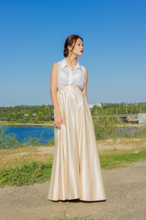 Portrait of a beautiful brunette girl in a blouse and long skirtの写真素材