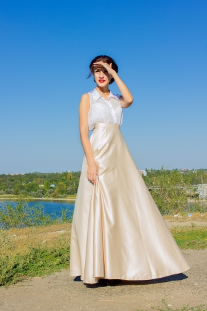 Portrait of a beautiful brunette girl in a blouse and long skirtの写真素材