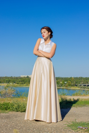 Portrait of a beautiful brunette girl in a blouse and long skirtの写真素材