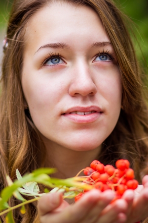 Portrait of a beautiful young woman with natural make-up in nature in autumnの写真素材