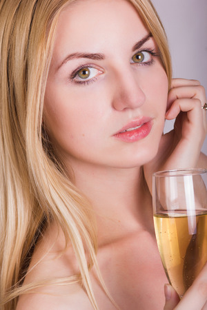 girl posing with a glass of champagne in her hands の写真素材