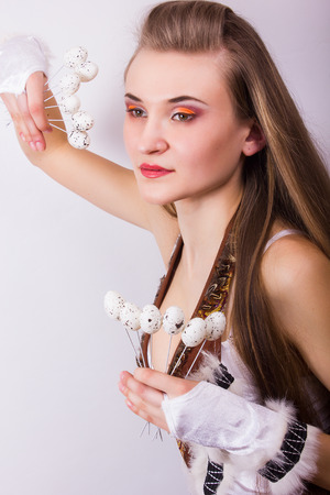 Portrait of beautiful young brown-haired woman with long hair  Girl dressed in costume posing with birds and quail eggs の写真素材