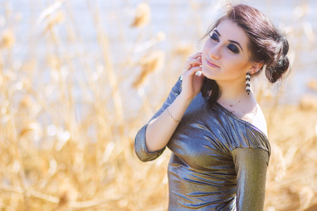 Young pretty brunette woman posing outdoor in summer meadow  Sensual girl posing in park
