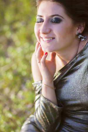 Luxury woman in a long black evening dress in the parkの写真素材