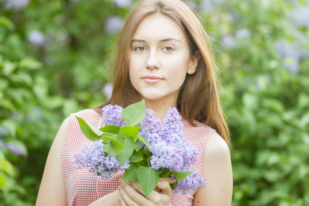 Portrait of a beautiful young woman with long brown hair that morning walks through landmark の写真素材