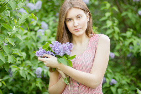 Portrait of a beautiful young woman with long brown hair that morning walks through landmark の写真素材