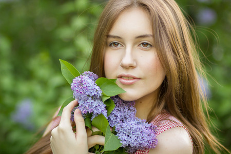 Portrait of a beautiful young woman with long brown hair that morning walks through landmark の写真素材