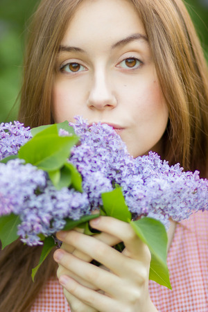 Portrait of a beautiful young woman with long brown hair that morning walks through landmark の写真素材