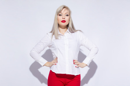 Portrait of a beautiful sexy blond woman with bright makeup on white backgroundの写真素材