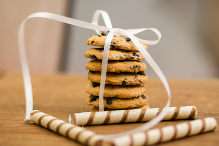 A stack of chocolate chip cookies tied with a ribbon