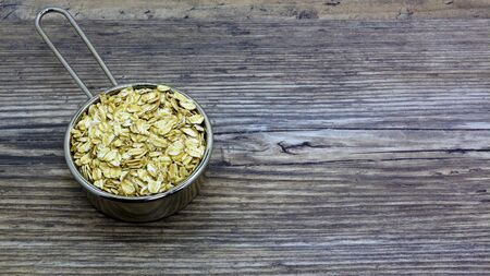 oatmeal or hercules flake close-up on a plate on wooden background. Healthy diet. Oatmeal porridge.の写真素材