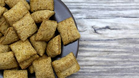 crackers on a plate on a wooden backgroundの写真素材