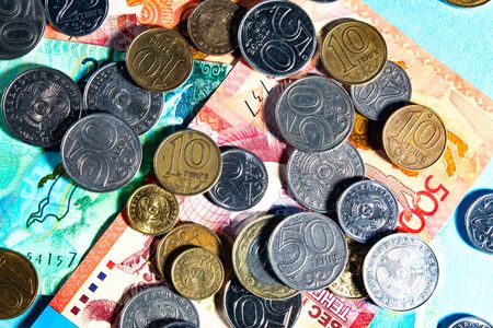 Tenge on a blue background with coins. Tenge banknotes. Coins Of Kazakhstan Tengeの写真素材