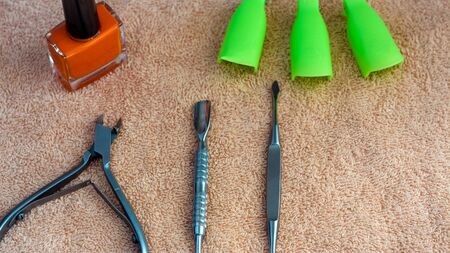 Equipment for beauty shop,cosmetic salon or beauty parlour.Manicure tools in the beauty salon.Equipment for manicure or pedicure salon.Scissors,pliers,tweezers, blade and nail the clamps on the table.の写真素材