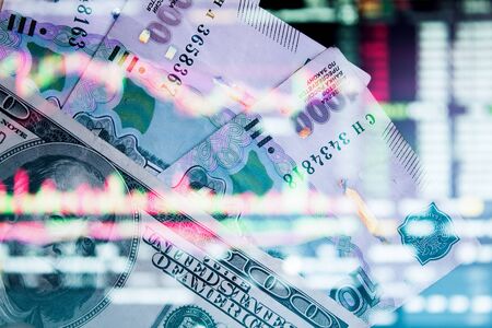 The Russian ruble with American dollar on the background of the trading chart. A thousand rubles close-up. Fall or rise of the ruble.の写真素材