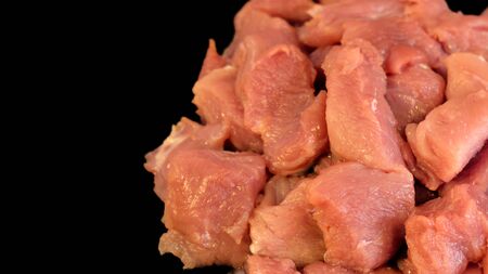 Meat on blackboard. Sliced pork. Minced fillet of red meat. Billets for barbecue or kebab. Meat tenderloin on a black background.の写真素材